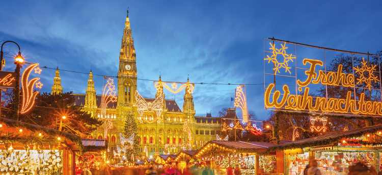 Bright Christmas lights at night at a Yuletide Market in front of the Rathaus | Vienna, Austria