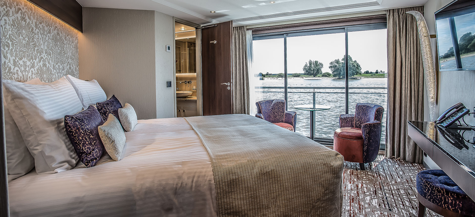 Deluxe suite with floor-to-ceiling windows and double bed